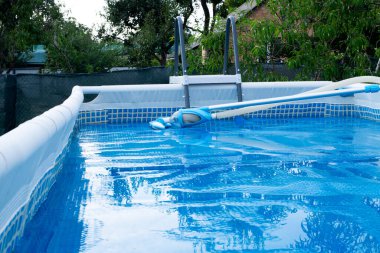 Swimming Pool with vacuum cleaner cleaning Tool. Solar film covers the pool.Film for heating water and protection pollution. Pool service clipart