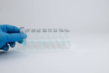 Bir laboratuvar tıbbi çalışanı analiz için test tüpü gösteriyor. Test tüpleri hazır.