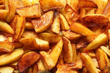Fried potato slices fixed with a close-up photo shooting. View from above. clipart