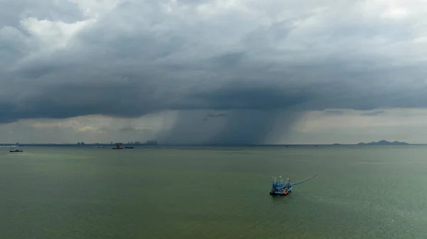 Small fishing boat sailing in sea storm background aerial view,