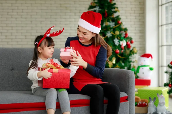 Happy special holiday of family mother and children with Christmas gifts on the floor at home, merry Christmas concept