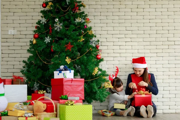 Happy special holiday of family mother and children with Christmas gifts on the floor at home, merry Christmas concept