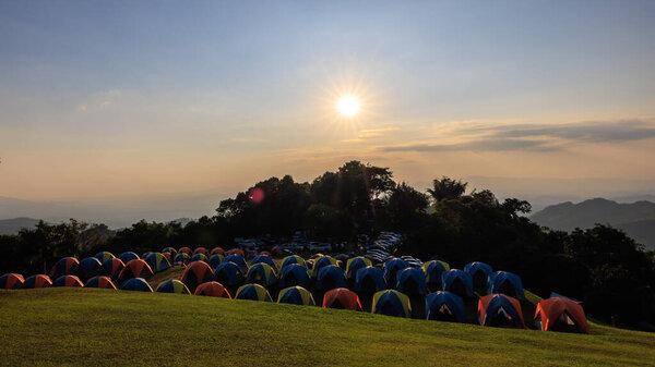 October 2022 Camping grounds Evening time the sun rays with blue cloud sky background at Doi Samer Dow National Park sri nan, view point and landmark attraction nan province, Thailand, Travel tourist relaxtion concept,