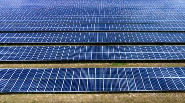  Blue Solar panel farm or solar power plantation.  Alternative renewable energy with photovoltaic cell industry. Green energy technology for future world concept, drone point of vie