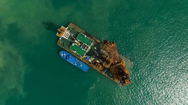 ship oil drilling rig in green sea aerial top view from drone