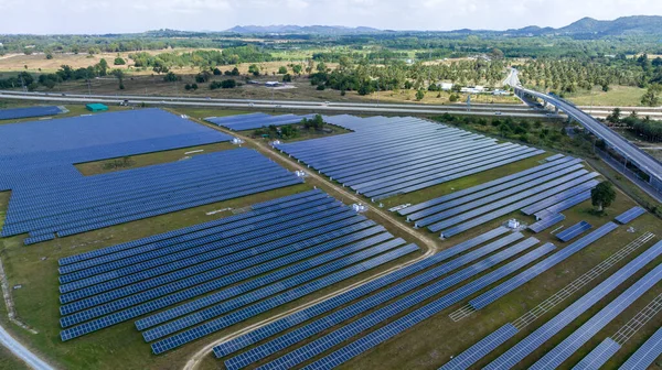 Blue Solar panel farm or solar power plantation.  Alternative renewable energy with photovoltaic cell industry. Green energy technology for future world concept, drone point of vie
