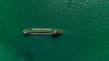 Oil Ship tanker or Liquid fied Petroleum Gas (LPG) sailing in green sea aerial top view from drone,