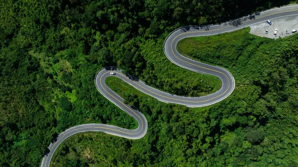 stock image aerial view drone shot ROAD No.1081 or shape number three of winding mountain road between Pua District, Nan Province, Thailand is highlight point and landmark that tourist like to take pictures of because of the beauty of the road