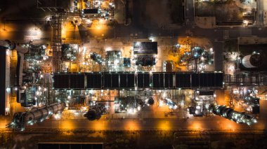 business and industrial area production plant or refinery crude oil and gas for transportatioon and export, aerial photography at night scene from drone,
