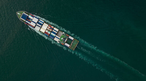 cargo container ship sailing full speed in sea to import export goods and distributing products to dealer and consumers across worldwide, by container ship Transport open sea. aerial view