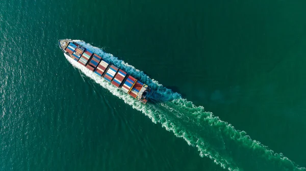 cargo container ship sailing full speed in sea to import export goods and distributing products to dealer and consumers worldwide, by container ship Transport business delivery service, aerial view photograph from drone,
