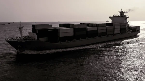 black and white of cargo container ship sailing full speed in sea and over background to import export goods and distributing products to dealer and consumers worldwide, by container ship Transport business and industry delivery service