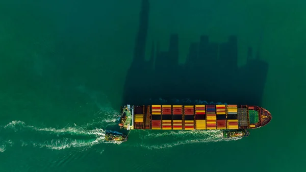 cargo container ship carrying in sea import export goods and distributing products to dealer consumers across Asia pacific and worldwide global business transportation by container ship open sea aerial view