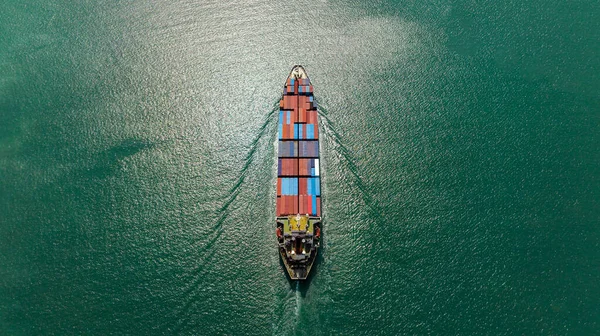 cargo container ship sailing in sea to import export goods and distributing products to dealer and consumers across worldwide, by container ship Transport business service.4k video aerial top view