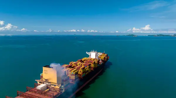cargo container ship sailing in green sea to import export goods and distributing products to dealer and consumers worldwide, by container ship Transport, business logistic delivery service, aerial view