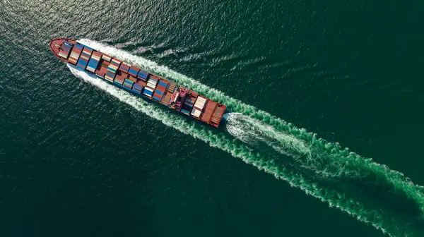 cargo container ship carrying in sea import export goods and distributing products to dealer consumers across Asia pacific and worldwide global business transportation by container ship open sea aerial top vie