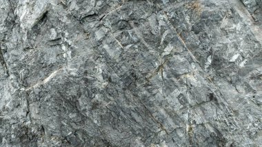Taş yüzeyinin çatlak gri rengi, doku, arkaplan soyutlaması için detay