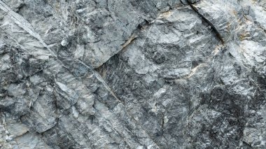 Taş yüzeyinin çatlak gri rengi, doku, arkaplan soyutlaması için detay