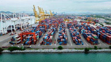 commercial port load and unloading cargo from container ship for import export by crane for distributing goods by trailers transported to customers and dealers, business and industry logistic service of international asia pacific in the ocean.