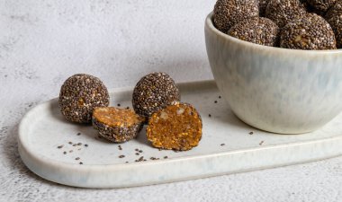 Healthy homemade delicious organic energy balls made from figs, nuts and chiha seeds on white background, closeup, copy space