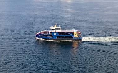 Kiel, Almanya-09.08.2025: Mavi SF Laboe yolcu feribotu durgun deniz suyunda seyreden turistlerle dolu, aşağıdan çekilen.