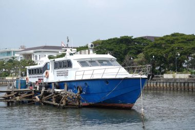 Jakarta, Indonesia on May 20,2024: The speedboat crossing to Bidadari Island is parked at the Marina Ancol beach pier. defocused