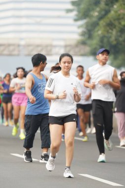 9 Haziran 2024 'te Endonezya' nın Jakarta kenti: Sudirman - Thamrin, Merkez Jakarta 'da sabah saatlerinde Arabasız Günü' nde egzersiz yapan Asyalı insanlar. Seçici odaklanma. Odaklanamadı