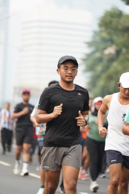 Jakarta, Endonezya 'da 12 Haziran 2024: Asyalılar Orta Jakarta' daki Sudirman-Thamrin bölgesinde koşuyorlar. Arabasız gün Sudirman - Thamrin. Odaklanamadı