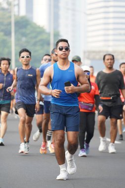 Jakarta, Endonezya 'da 12 Haziran 2024: Asyalılar Orta Jakarta' daki Sudirman-Thamrin bölgesinde koşuyorlar. Arabasız gün Sudirman - Thamrin. Odaklanamadı