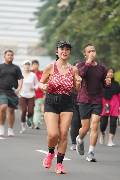 stock image Jakarta, Indonesia on June 12,2024 : Asian people are jogging in the Sudirman-Thamrin area, Central Jakarta. car free day Sudirman - Thamrin. defocused