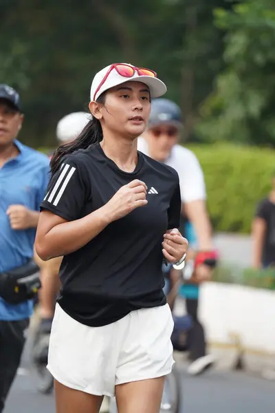 stock image Jakarta, Indonesia on June 12,2024 : Asian people are jogging in the Sudirman-Thamrin area, Central Jakarta. car free day Sudirman - Thamrin. defocused