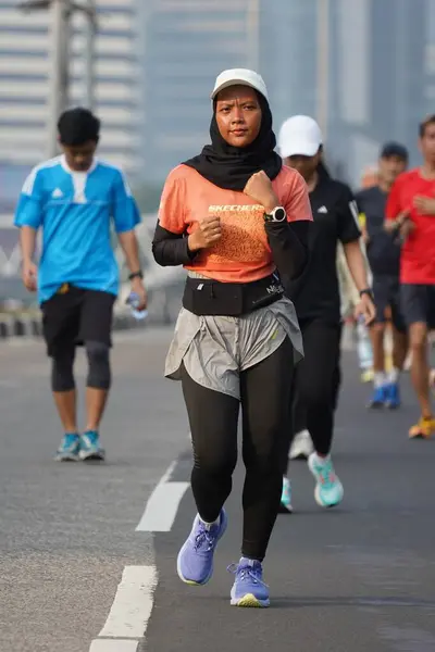 stock image Jakarta, Indonesia on June 12,2024 : Asian people are jogging in the Sudirman-Thamrin area, Central Jakarta. car free day Sudirman - Thamrin. defocused