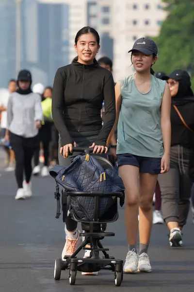 stock image Jakarta, Indonesia on June 12,2024 : Asian people are jogging in the Sudirman-Thamrin area, Central Jakarta. car free day Sudirman - Thamrin. defocused