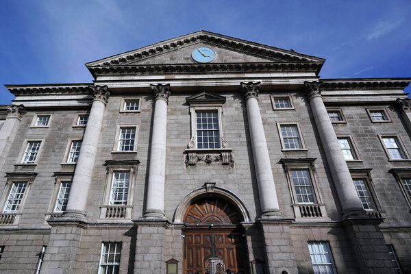 Dublin, Ireland - March 2023:  Trinity College, University of Dublin, facade of Regent House with front gate entrance to the old central campu