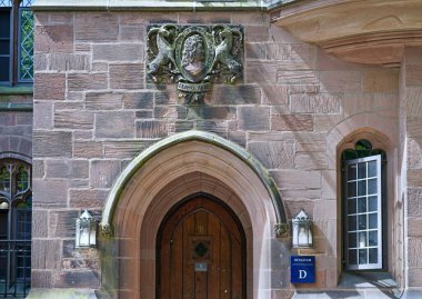 Old stone building at Yale University with bust of the founder, Elihu Yale clipart