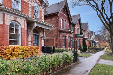 Street of old Victorian style houses with gables clipart