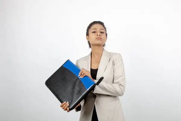 Corporate office lady holding a folder and giving presentation. Young woman in formal wear wearing white blazer against white background.