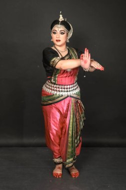 Renkli kostümler içinde Odissi dansı yapan bir kadın. Hint klasik dans formları.