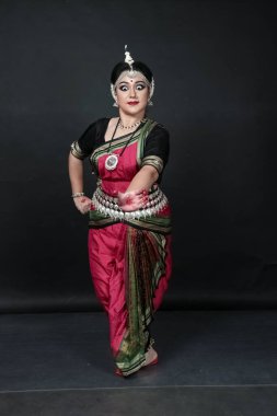 Renkli kostümler içinde Odissi dansı yapan bir kadın. Hint klasik dans formları.