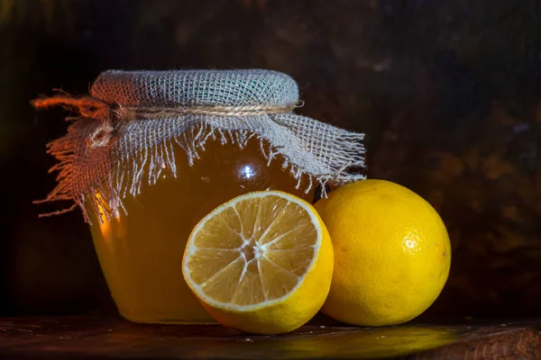 stock image Honey yellow Lemon  half slice wooden table  dark backgrond jar Alternative medicine concept. flu burlap sack