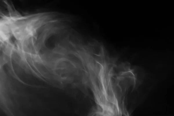 Beautiful white abstract steam from tea or coffee hot water  on a black isolated background Smoke pollution, cloud, cigarette, gas, dry ice ghost concept