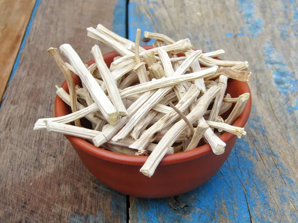 Asparagus racemosus or shatavari roots in a bowl on wooden background 
