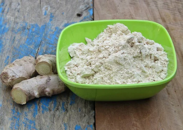 stock image Ginger powder in a bowl on old wooden background 