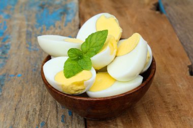 Ahşap bir kasede haşlanmış tavuk yumurtası. 