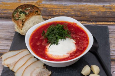 Borsch. Traditional Ukrainian borsch with sour cream in a bowl. National dish of Ukraine: red borscht, lard, garlic.