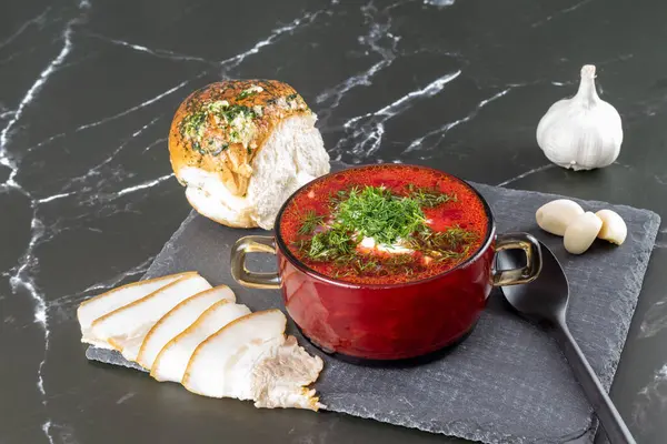 Borsch. Traditional Ukrainian borsch with sour cream in a bowl. National dish of Ukraine: red borscht, lard, garlic.