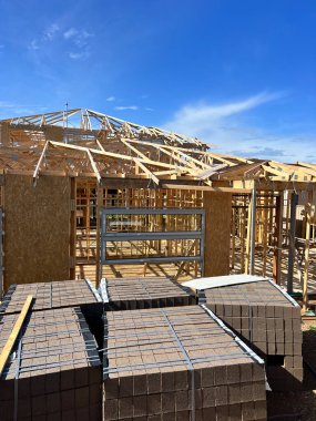 New residential construction home framing against a blue sky. High quality photo