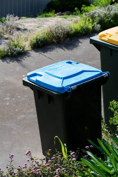 stock image Australian home rubbish bins set provided by local council on back yard in Australian suburb. High quality photo