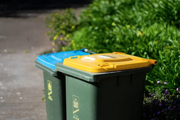 stock image Australian home rubbish bins set provided by local council on back yard in Australian suburb. High quality photo