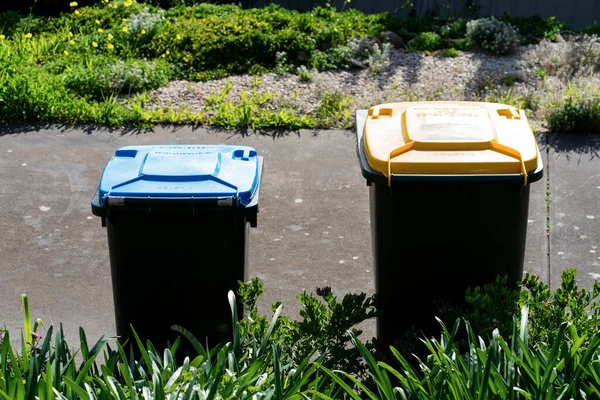 stock image Australian home rubbish bins set provided by local council on back yard in Australian suburb. High quality photo